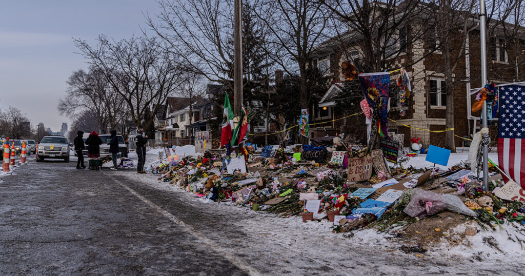 Street view of the Renee Good Roadside Memorial on Portland Avenue in Minneapolis, Minnesota, marking the location where her vehicle crashed after being fired upon by ICE agents in a residential neighborhood. Photo by Awe Video & Photo Studio.